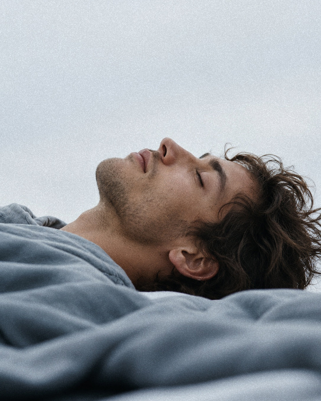 Man lying on his back with his eyes closed